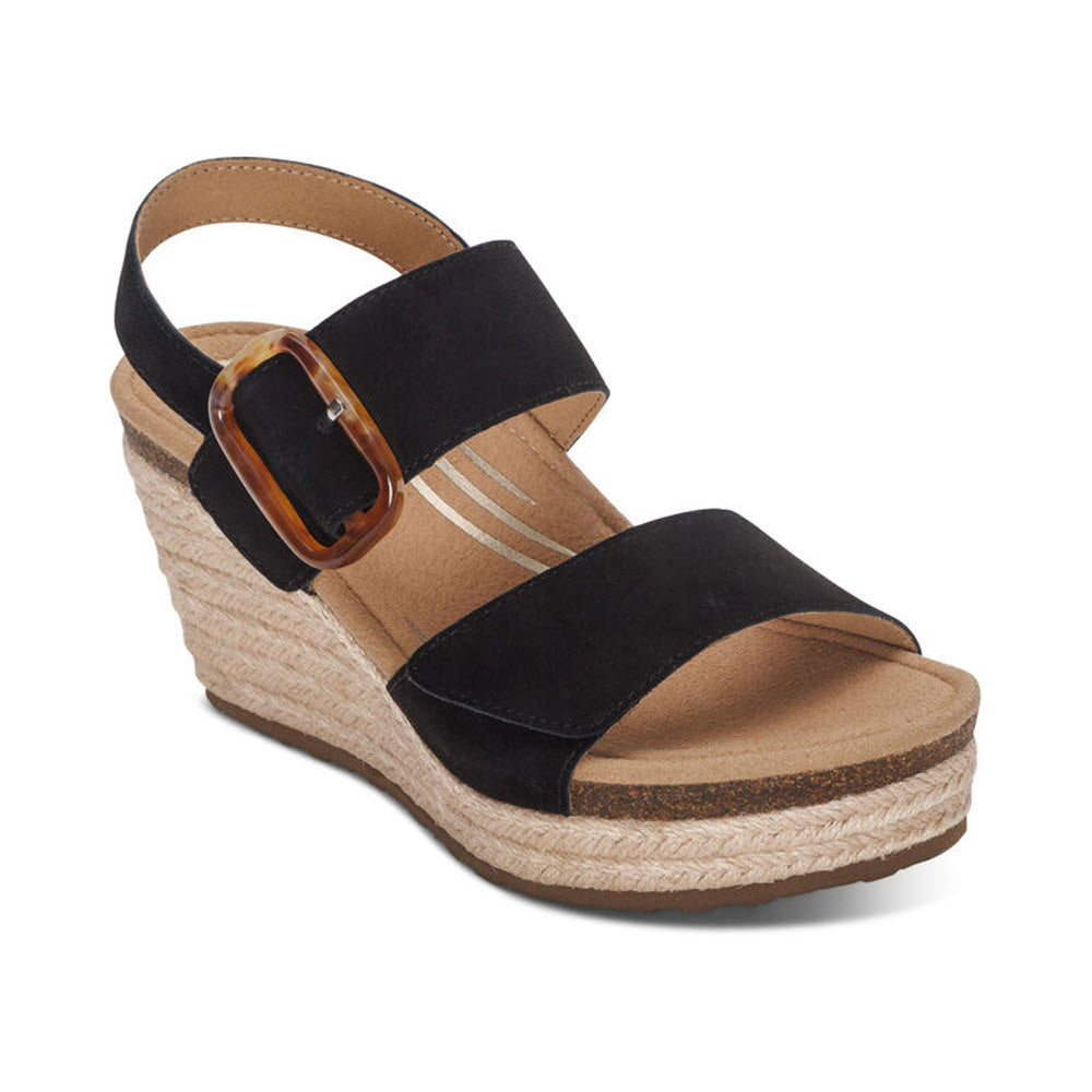 A black wedge sandal with wide straps and a large brown buckle, featuring a cork sole, jute-wrapped platform, and a memory foam footbed for added comfort: AETREX ASHLEY BLACK - WOMENS by Aetrex.