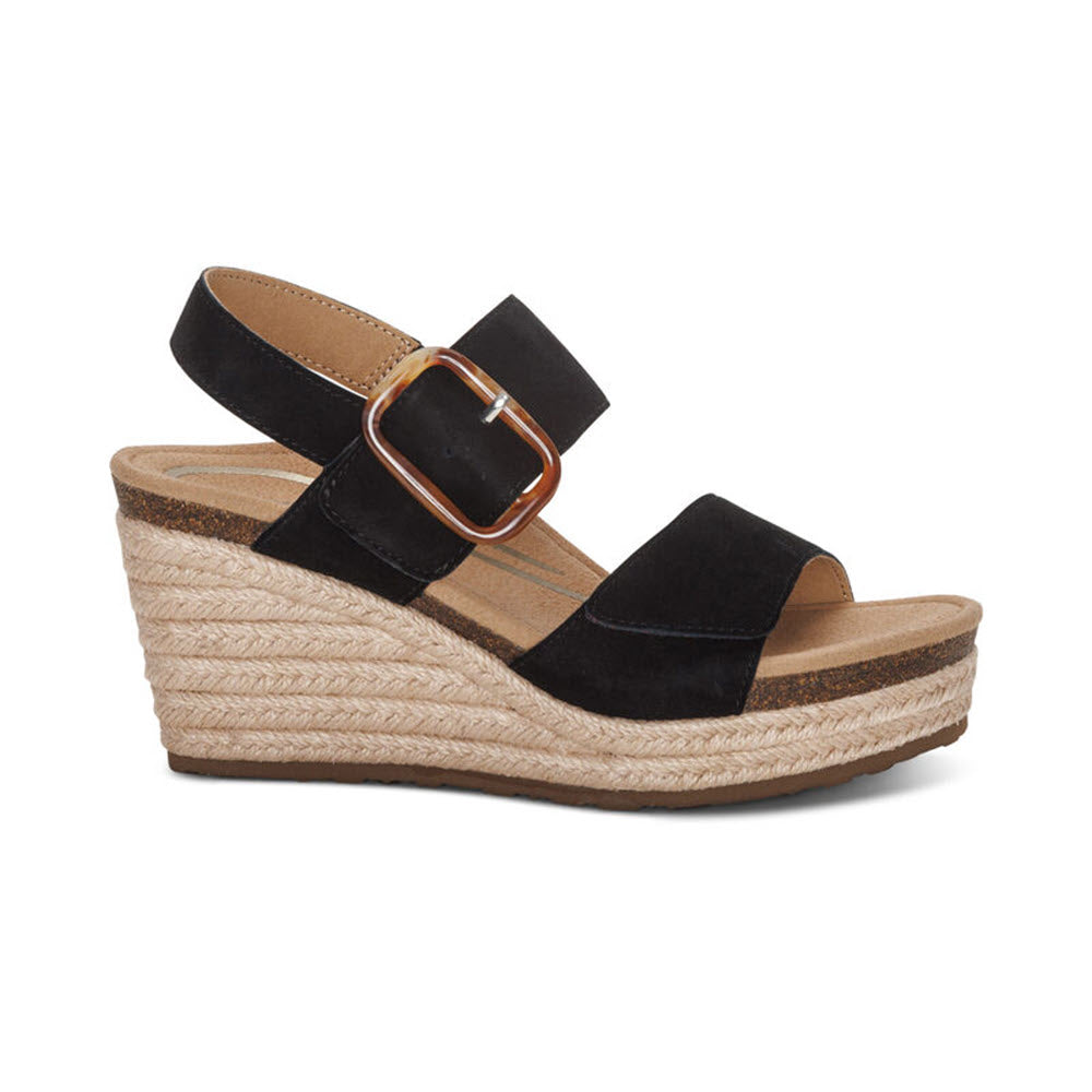 Aetrex AETREX ASHLEY BLACK - WOMENS: A black wedge sandal with a large buckle, an espadrille-style platform sole, and a memory foam footbed for added comfort.