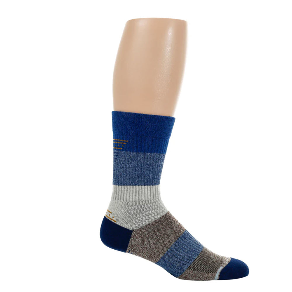 A mannequin leg displays a DR MOTION COMPRESSION CREW SOCK DENIM - MENS with blue, gray, and white sections, a dark blue toe and heel, and breathable mesh for added comfort by Dr Motion.