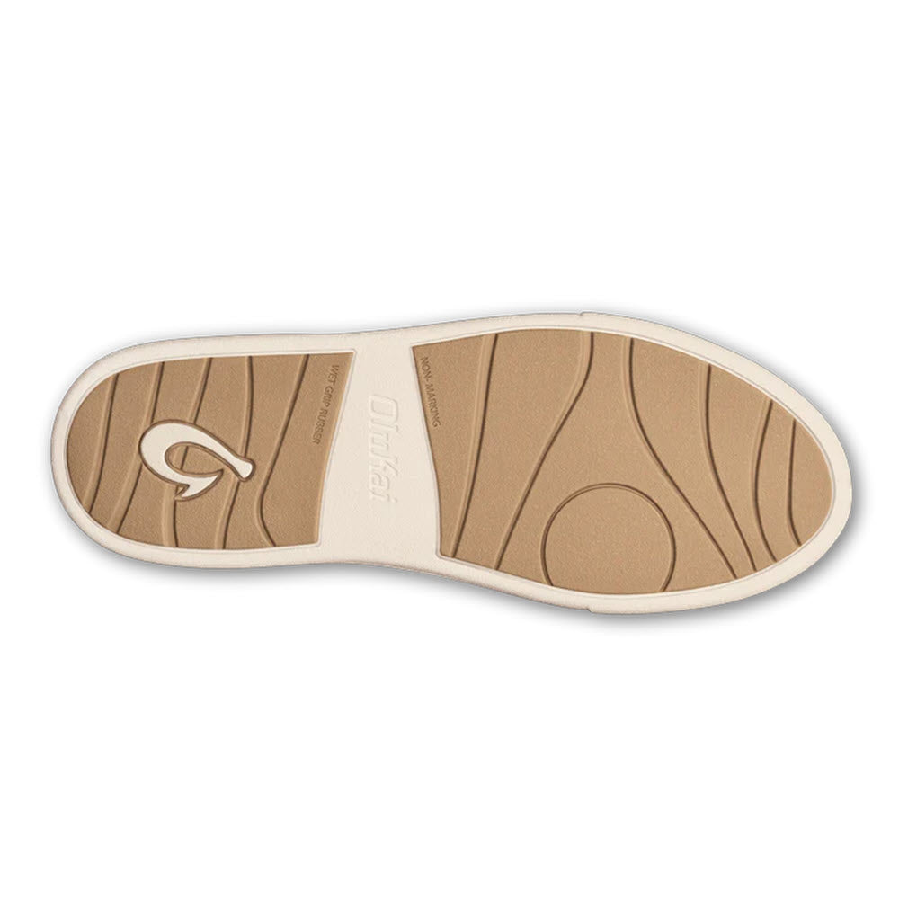 The outsole of the OLUKAI KILEA OFF WHITE BAMBOO - WOMENS court sneaker from Olukai features wavy tread patterns and a logo on its brown, textured sole, offering cloud-like comfort.