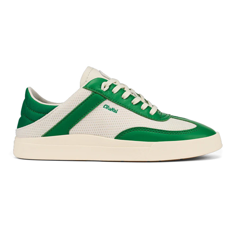 The OLUKAI KILEA OFF WHITE BAMBOO by Olukai is a low-top court sneaker featuring white perforated leather, green leather accents, white laces, and a white rubber sole. It offers cloud-like comfort perfect for a laid-back beach lifestyle.