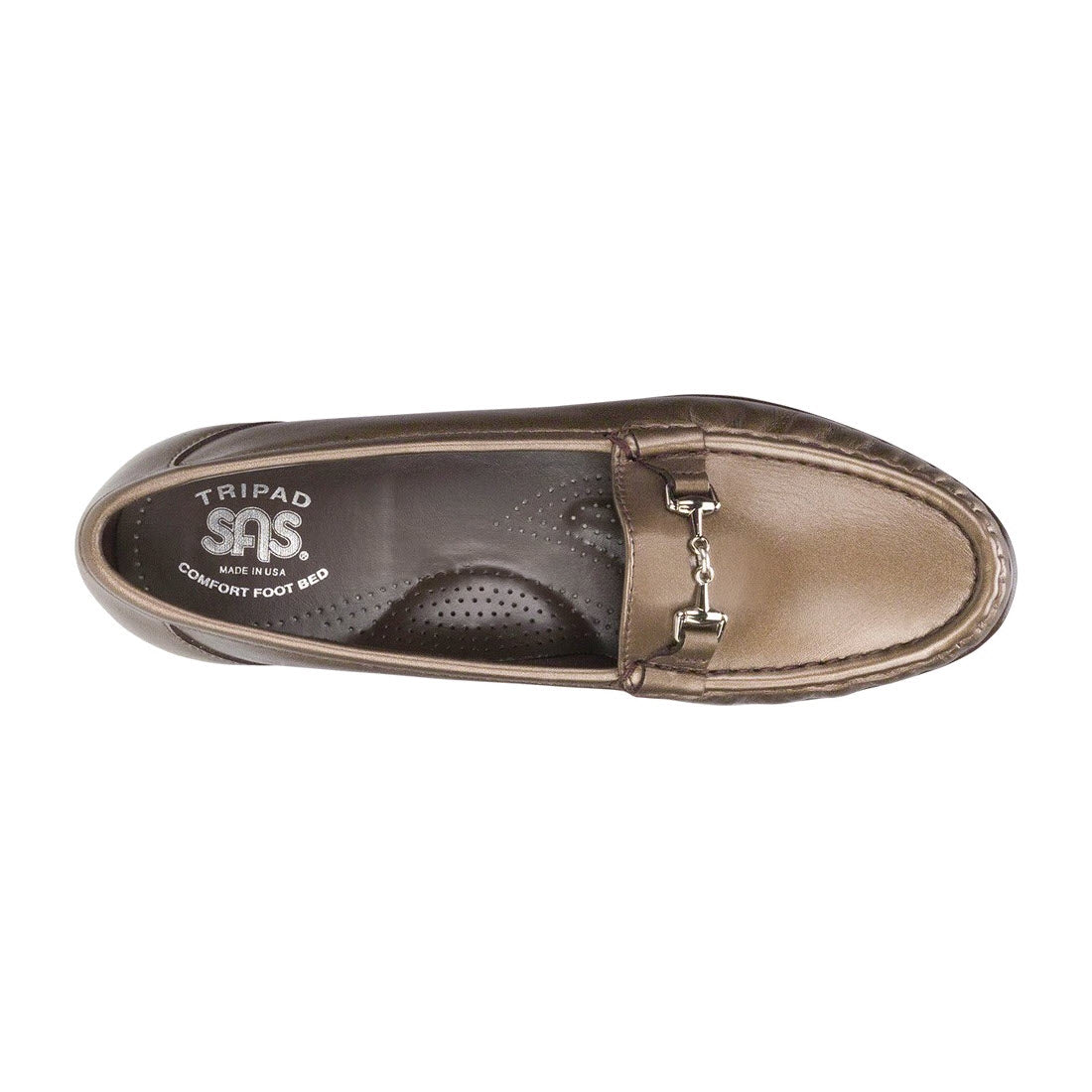 Top view of a single brown leather SAS Metro Bronze - Womens slip-on loafer with a silver buckle detail and visible brand label &quot;TRIPAD SAS Comfort Foot Bed&quot; inside. This stylish shoe also features the SAS Tripad Cushion insole for extra comfort.