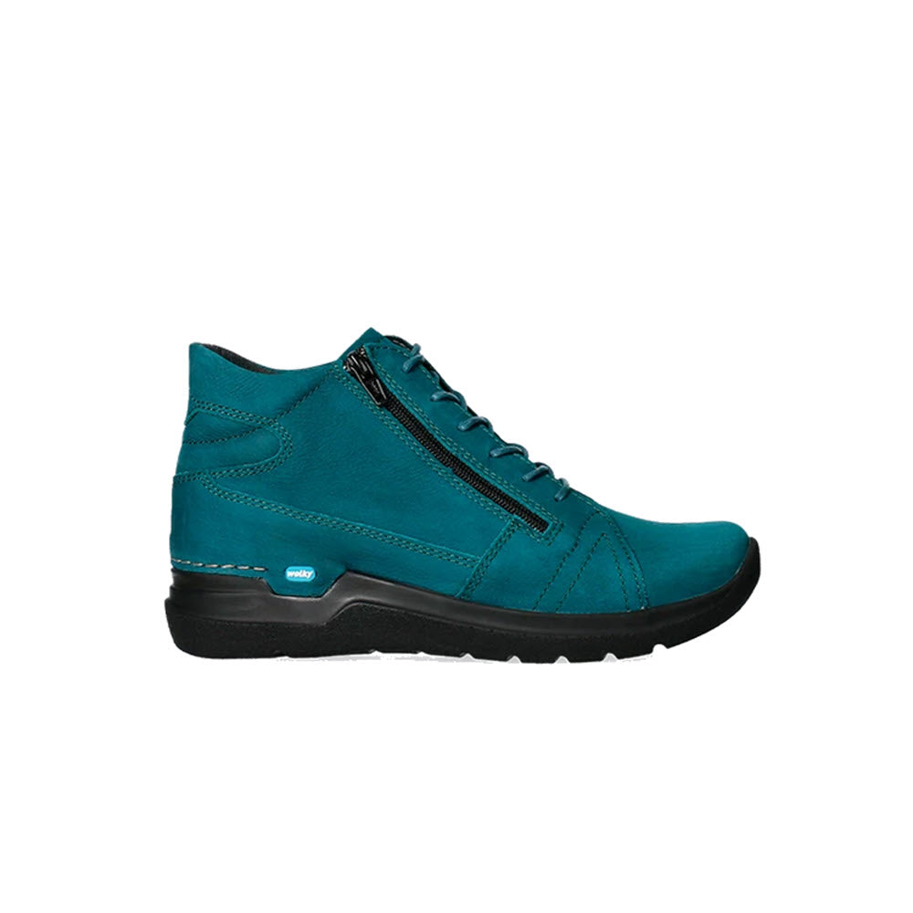 A teal WOLKY WHY ANTIQUE NUBUCK PETROL - WOMENS ankle boot with a zipper on the side, white stitching accents, and a lightweight PU sole for the best walking comfort. Easy to put on and take off with its convenient design by Wolky.