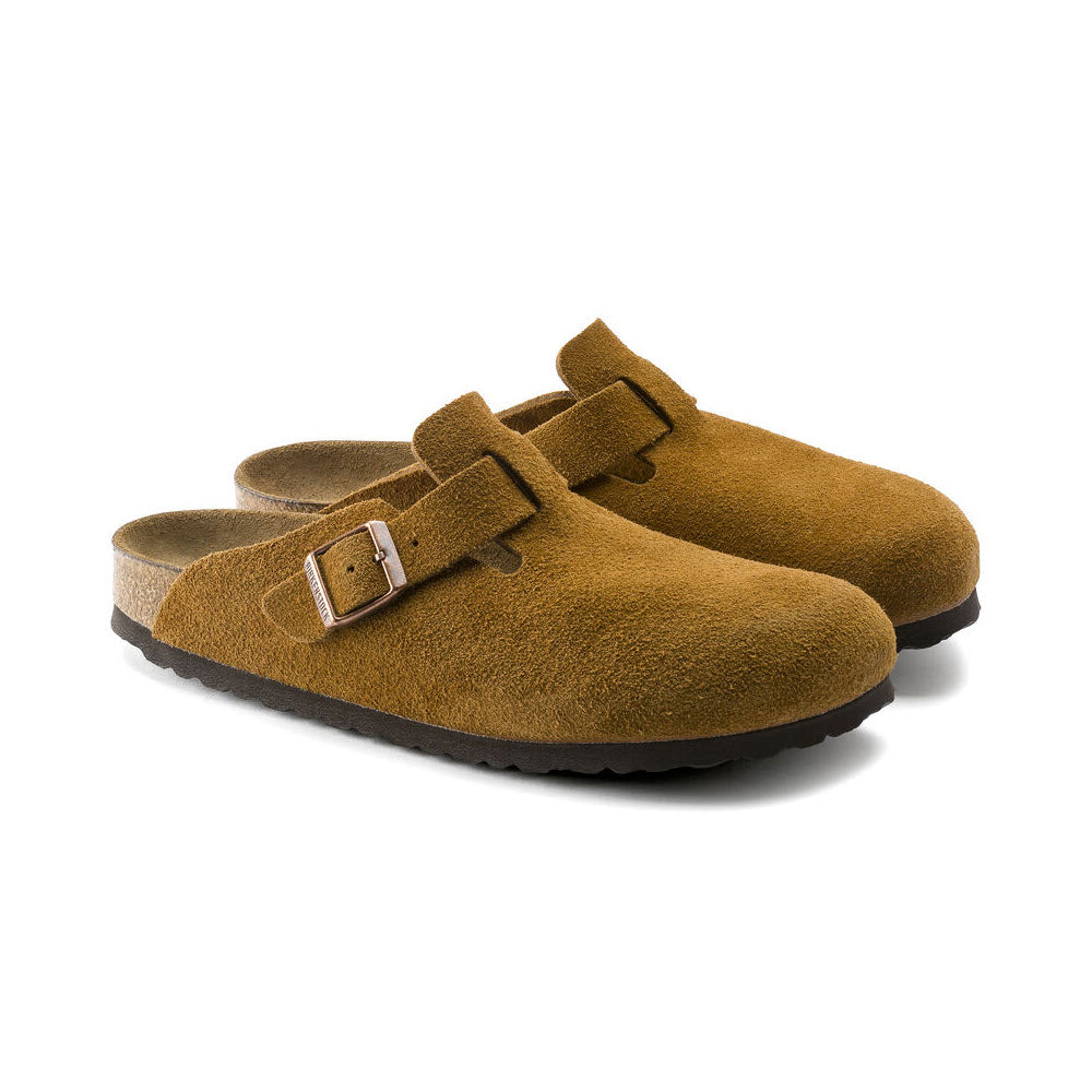 A pair of Birkenstock BIRKENSTOCK BOSTON MINK - WOMENS with adjustable straps, a soft footbed, and black rubber soles. Perfect for the fashion-forward individual.