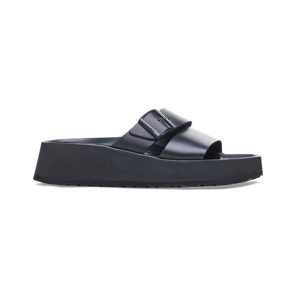 The Birkenstock Almina Black for women is a platform sandal with a wide strap, buckle detail, and contoured footbed for ultimate comfort.