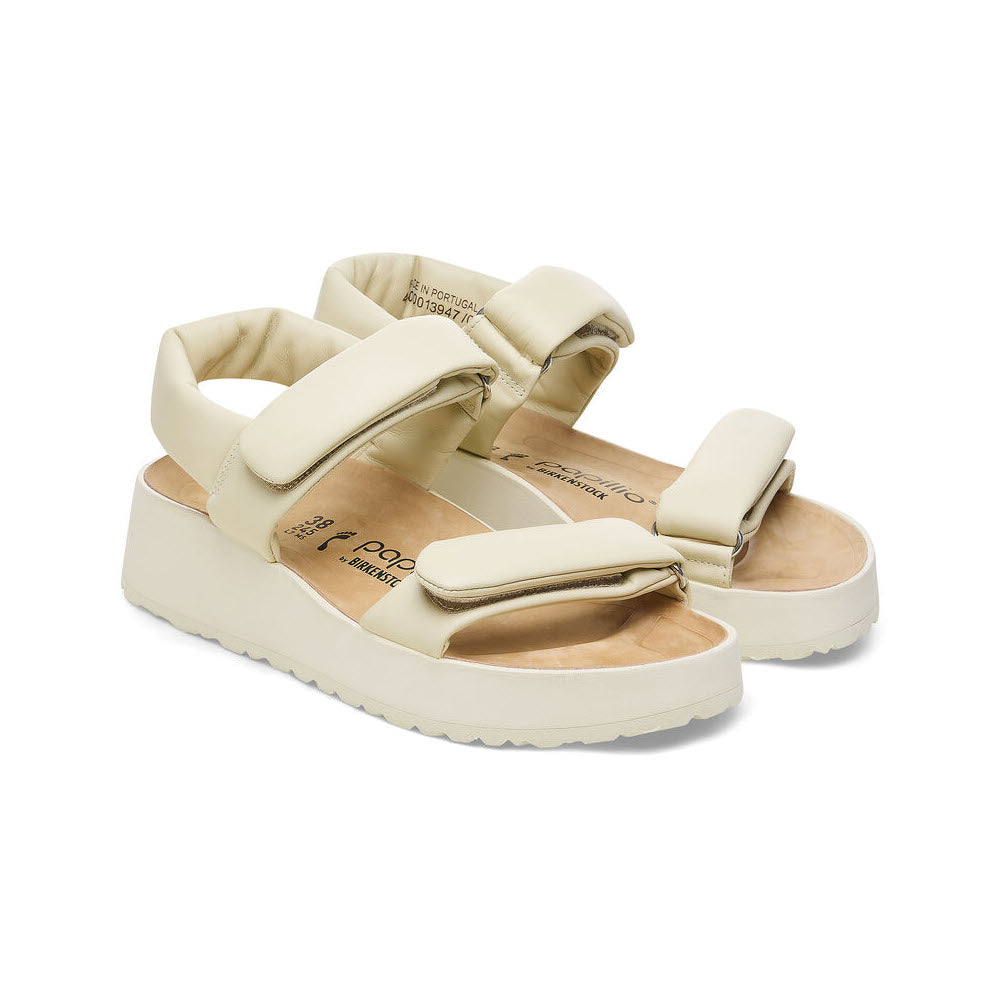 A pair of beige platform sandals with thick adjustable straps and a contoured footbed for ultimate comfort, the BIRKENSTOCK THEDA ECRU - WOMENS by Birkenstock.