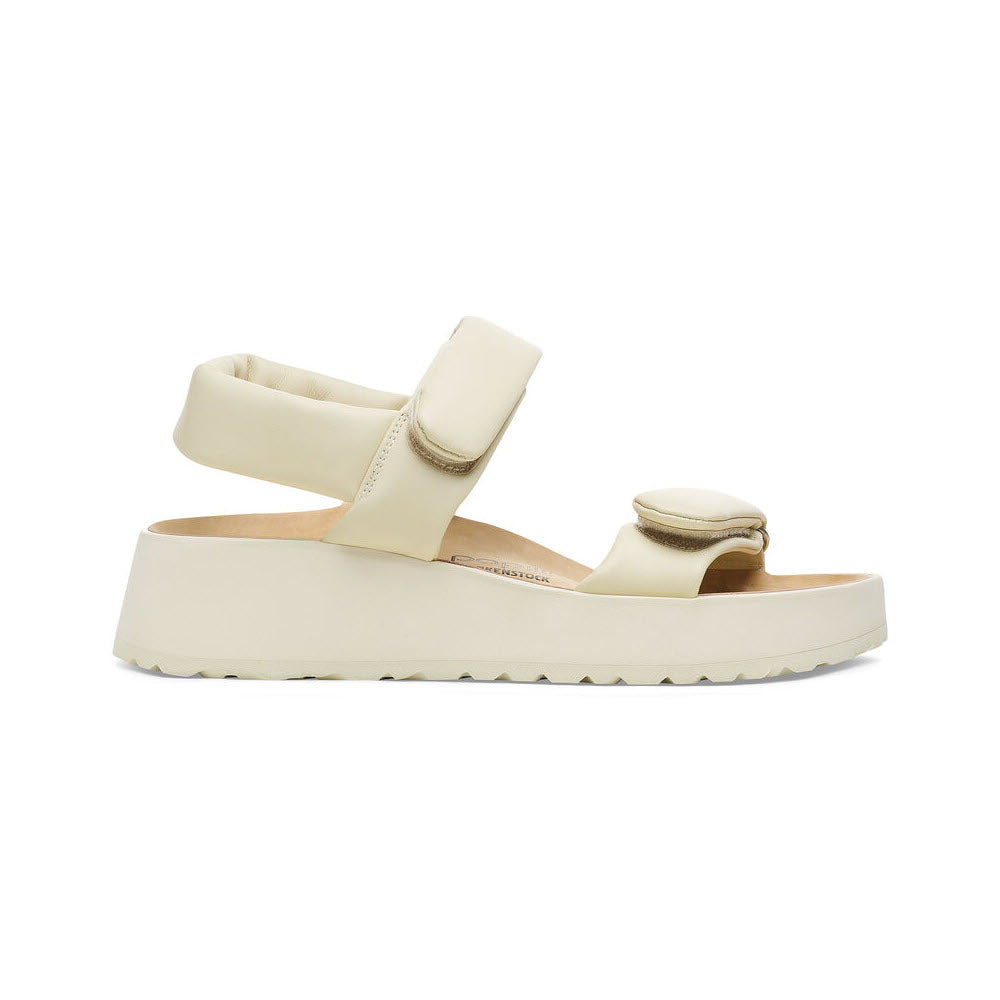 A BIRKENSTOCK THEDA ECRU - WOMENS with a padded strap across the toes, a Velcro ankle strap, and a slight wedge design. Featuring Birkenstock’s signature contoured footbed for ultimate comfort.