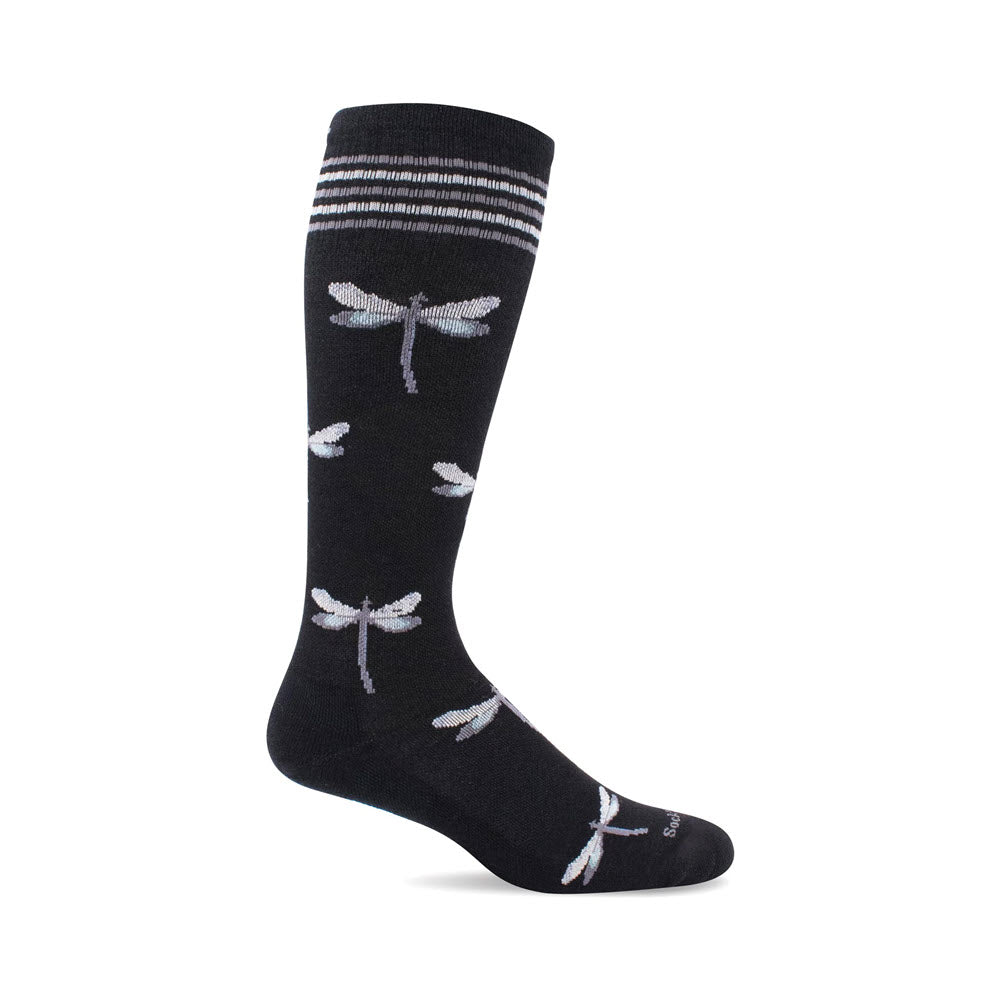 The Sockwell SOCKWELL DRAGONFLY 15-20MMHG COMPRESSION SOCKS BLACK - WOMENS, a black knee-high sock featuring a pattern of white and light blue dragonflies, three white stripes near the top, and graduated compression for added support during travel.