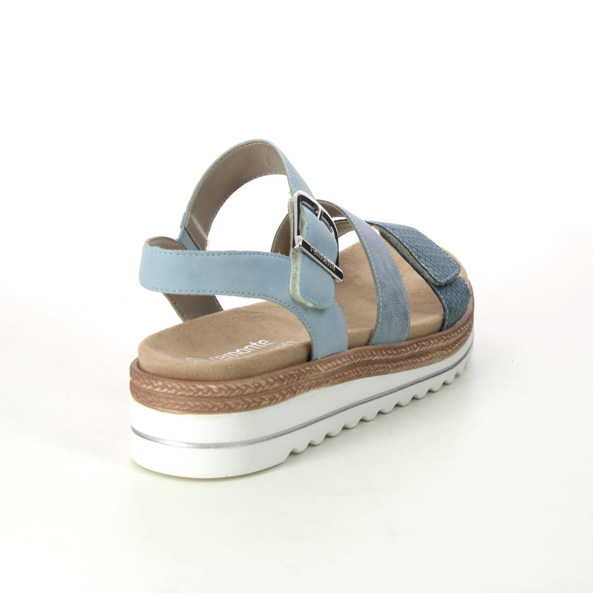 The REMONTE CITY WALKER GLADIATOR SANDAL BLUE - WOMENS by Remonte is displayed from the rear left angle, highlighting its adjustable straps and chunky white platform sole with shock-absorbing properties for added comfort.