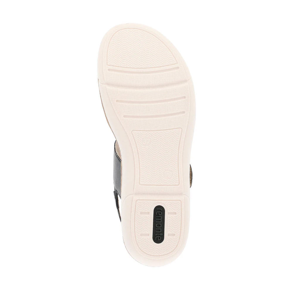 A white rubber sole of the REMONTE BIG BUCKLE COMFORT SANDAL BLACK/GOLD - WOMENS, with minimal tread patterns and the word &quot;Remonte&quot; near the heel area, reminiscent of stylish sandals.