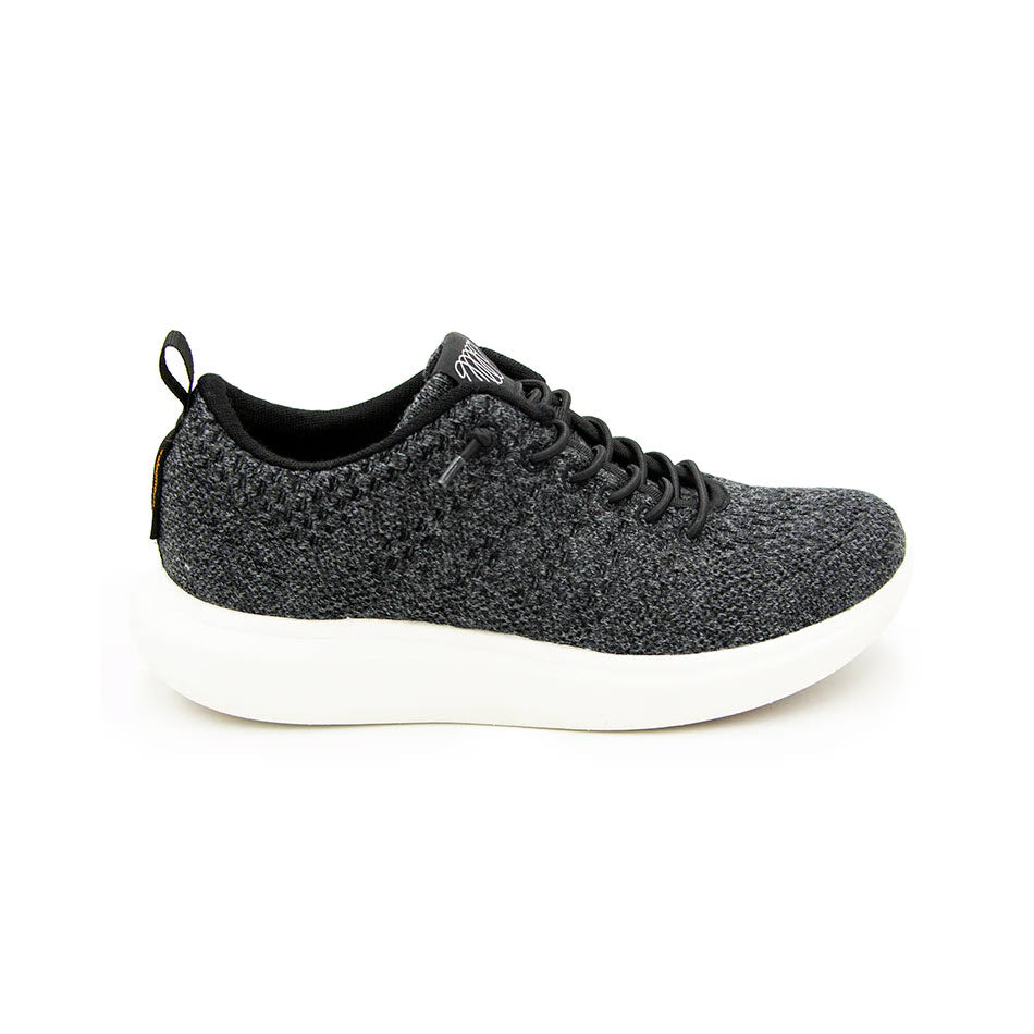 The Woolloomooloo Coogee Black - Adults sneaker, made with Merino wool and featuring white soles, a textured fabric, and black laces, is displayed against a plain white background.