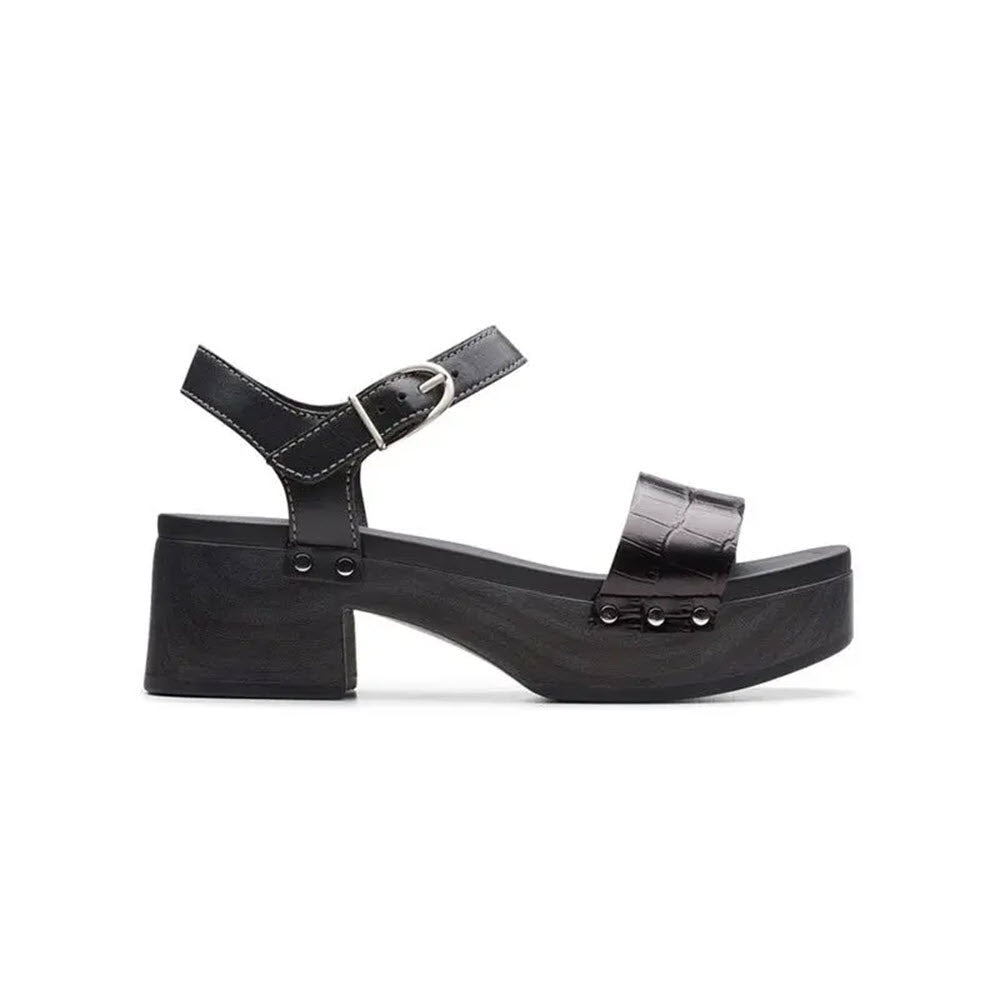 Side view of the Clarks SIVANNE BAY BLACK women&#39;s platform sandal, featuring butter-soft black leather uppers, a chunky heel, an ankle strap with buckle, and a wide front strap with a textured pattern.