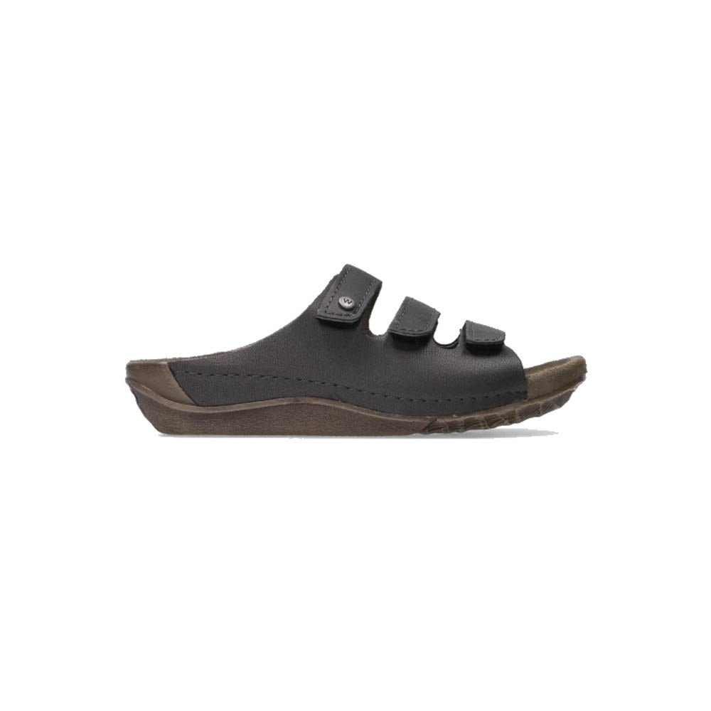 A side view of the Wolky WOLKY NOMAD INOX - WOMENS, a black, open-toe trekking sandal with two supportive straps and a wear-resistant brown sole.