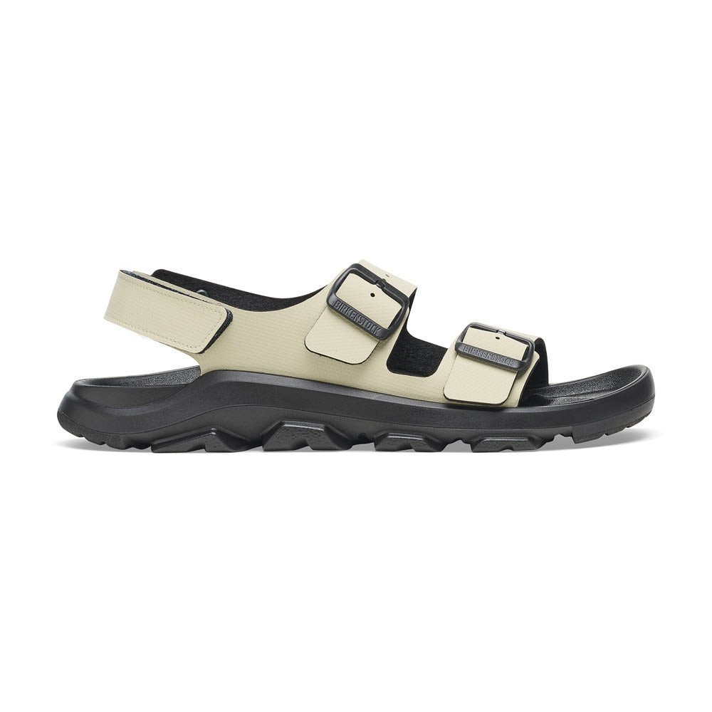 A beige and black sandal with two adjustable straps, a thick, highly functional sole, and a waterproof footbed: the Birkenstock BIRKENSTOCK MOGAMI TERRA OASIS EUCALYPTUS - WOMENS.