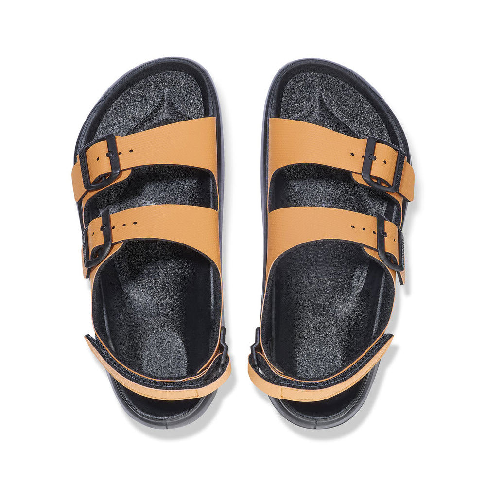 A pair of BIRKENSTOCK MOGAMI TERRA OASIS BURNT ORANGE - WOMENS sandals with tan straps, black buckles, and a rugged PU sole for all-terrain grip, displayed side by side on a white background.