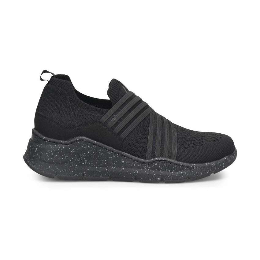 Meet the ALIGN CELESTIA BLACK - WOMENS by Align: a stylish and lightweight black slip-on sneaker with a speckled sole and textured knit upper. It features horizontal elastic straps for added support, along with a slip-resistant outsole to ensure stability and comfort in every step.