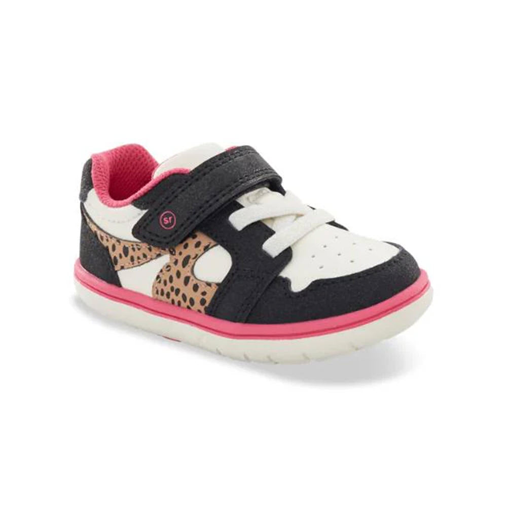 The STRIDE RITE SRT LONDON LEOPARD - KIDS by Stride Rite is a child&#39;s sneaker adorned with black, white, and pink details. It features a cheetah print on the sides, a black Velcro strap for added stability, and a white sole engineered for optimal traction.