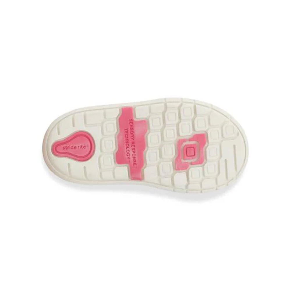 The sole of a Stride Rite SRT London Leopard - Kids shoe boasts a white and pink tread design that incorporates sensory response technology labels, providing optimal traction for enhanced stability.