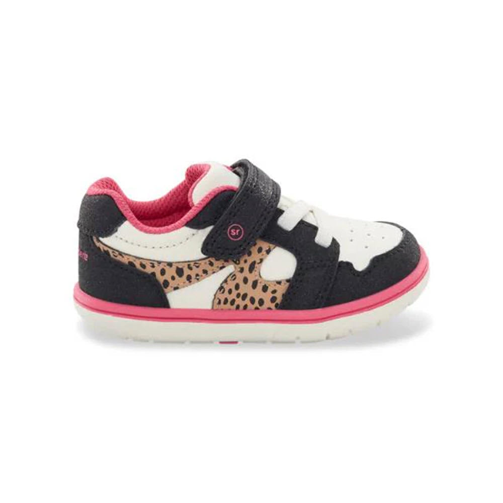 The STRIDE RITE SRT LONDON LEOPARD – KIDS by Stride Rite is a child&#39;s sneaker featuring black, white, and pink colors with a leopard print accent. It offers optimal traction with its hook-and-loop strap for added grip and is displayed on a white background.