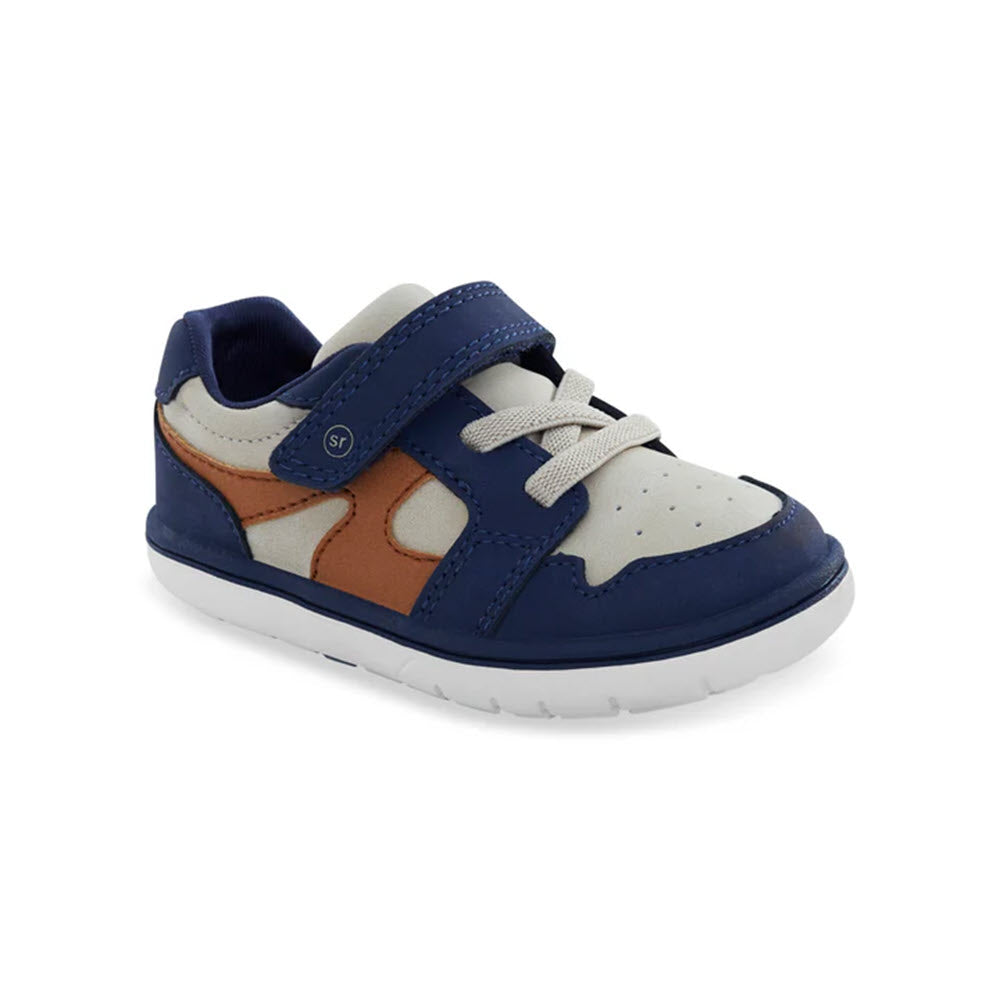 A single child&#39;s Stride Rite SRT London Taupe sneaker, featuring a blue, white, and brown color scheme, white laces, and a Velcro strap. It boasts the durable SRtech sole for added support.