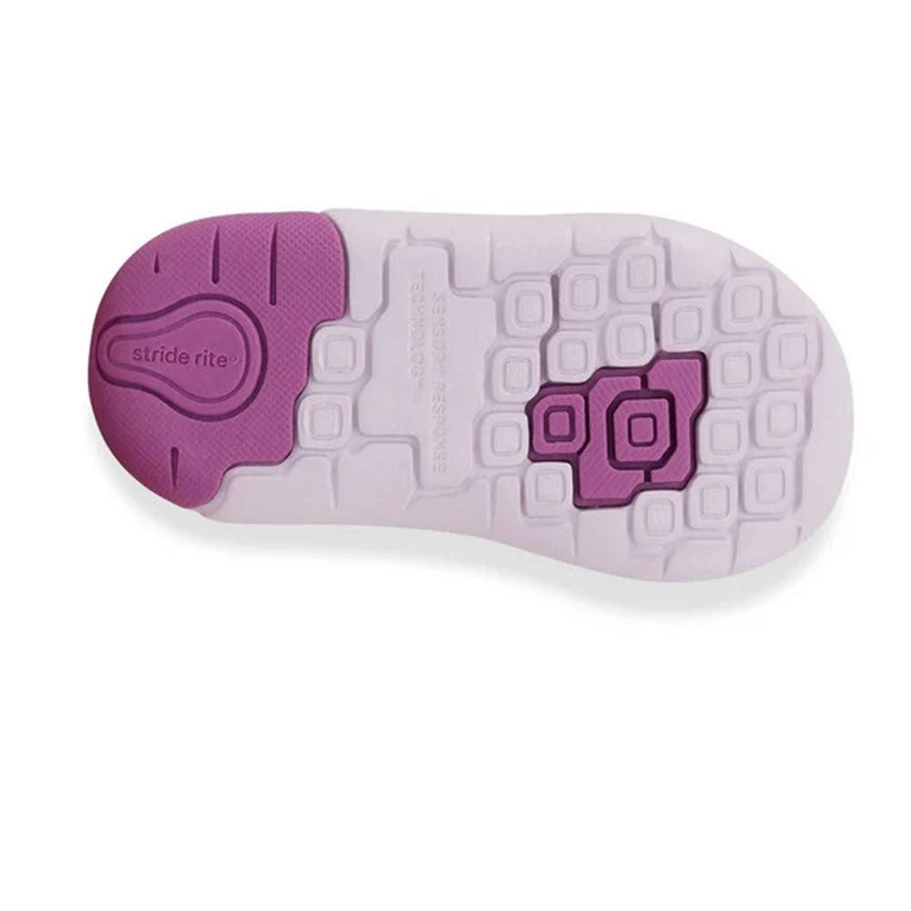 Bottom view of a white and purple children&#39;s shoe with rectangular tread patterns, the words &quot;Stride Rite SRT Ian Purple - Kids&quot; on the heel, and a memory foam footbed for added comfort.