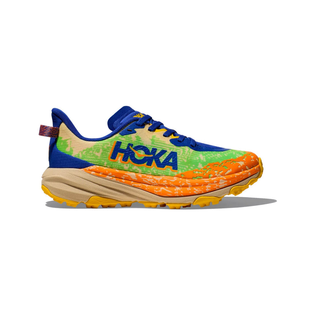 The HOKA SPEEDGOAT 6 YOUTH ULTRAMARINE - KIDS, a vibrant multi-colored running shoe by Hoka, showcases a blue tongue, green and orange upper crafted from lightweight woven material, a beige midsole with an internal support chassis, and a yellow outsole, displayed on a white background.