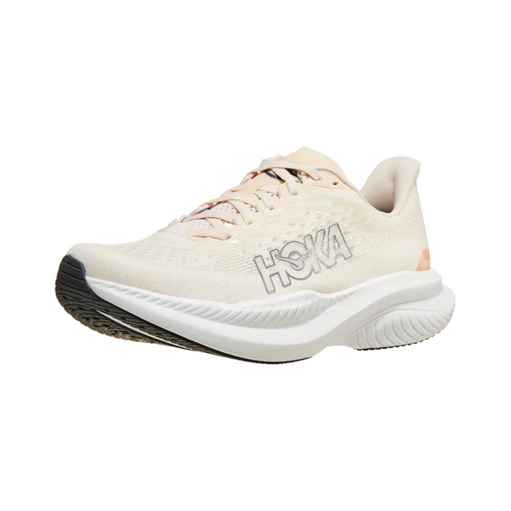 The HOKA MACH 6 EGGNOG/VANILLA - WOMENS is a light beige road running shoe that prominently features the word &quot;HOKA&quot; on the side. It boasts a thick white midsole and a black outsole, making it perfect for daily training. Designed to provide comfort and performance, the new Hoka Mach 6 is an ideal choice for runners.