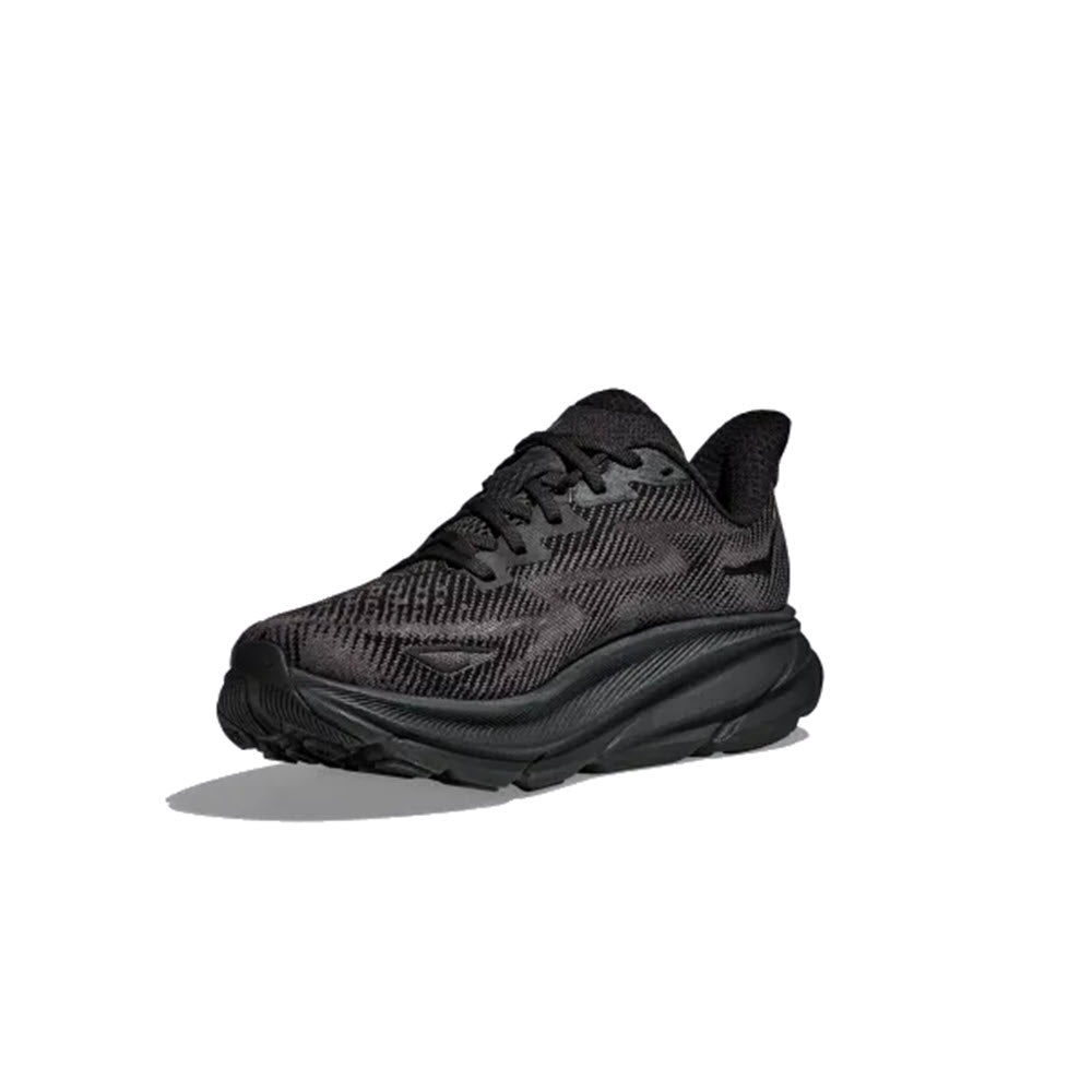 The Hoka Clifton 9 Black/Black for women, featuring a thick, cushioned sole and a breathable engineered mesh upper, is shown against a white background.