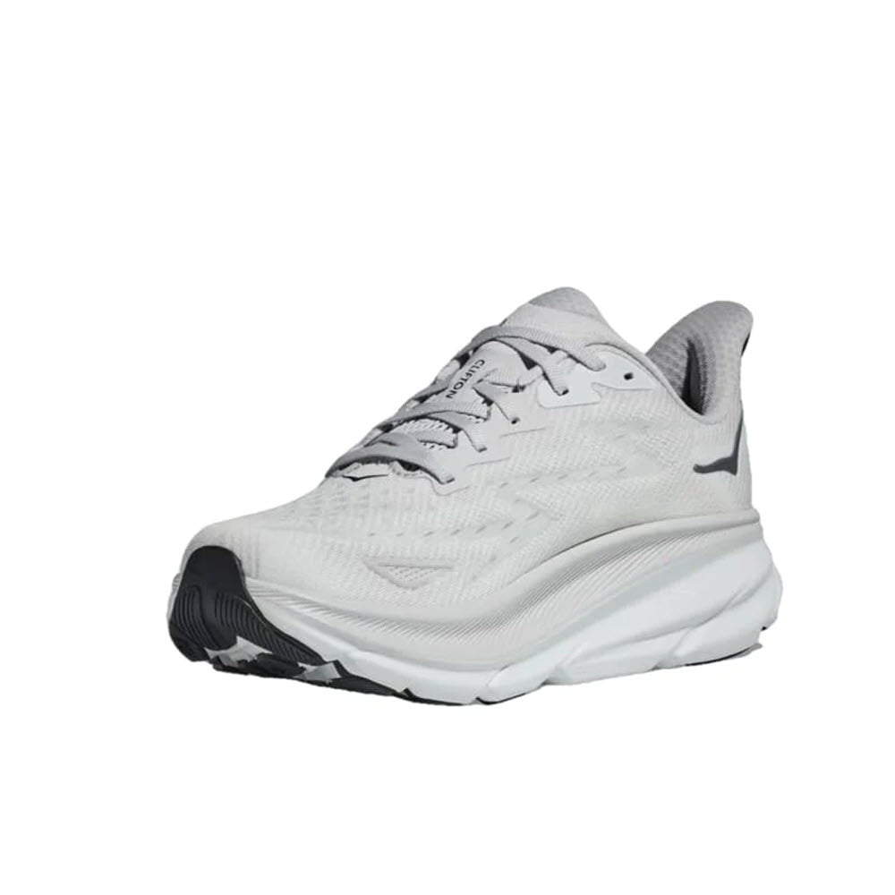 A single Hoka Clifton 9 athletic running shoe in the Nimbus Cloud/Steel Wool colorway, featuring a light gray upper with a thick white cushioned sole and black tread. The shoe includes responsive foam for added comfort. Displayed on a plain white background.