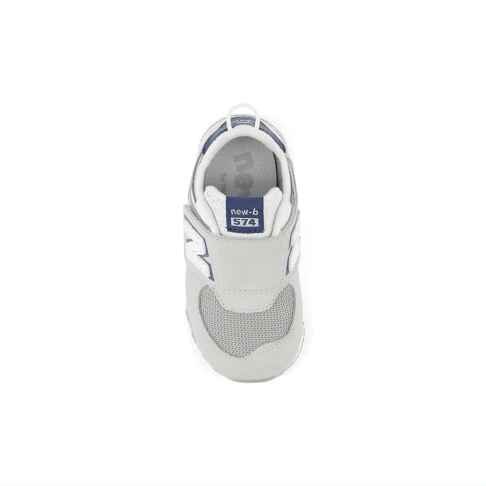 Top view of a New Balance 574 sneaker in Brighton Grey with NB Navy accents for toddlers, offering reliable comfort and stylish versatility.