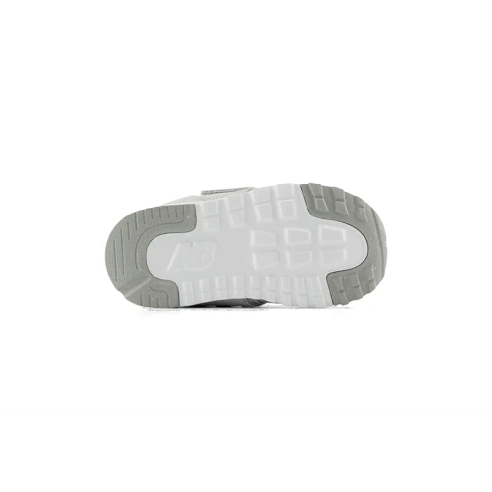 Bottom view of the New Balance 574 Brighton Grey/NB Navy sneakers for toddlers showing the tread pattern, highlighting its stylish versatility.