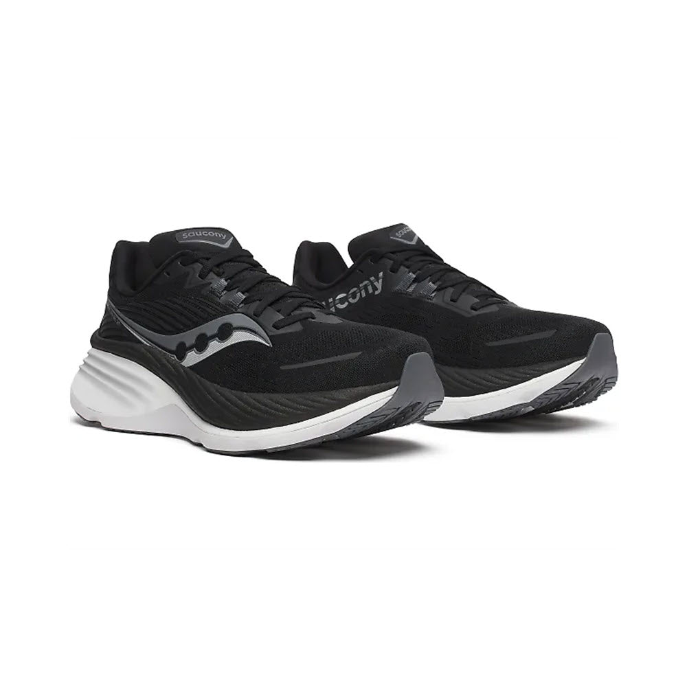 A pair of black athletic shoes with white soles, the Saucony Hurricane 24 Black/Carbon - Women&#39;s features dual-cushioning for maximum comfort.