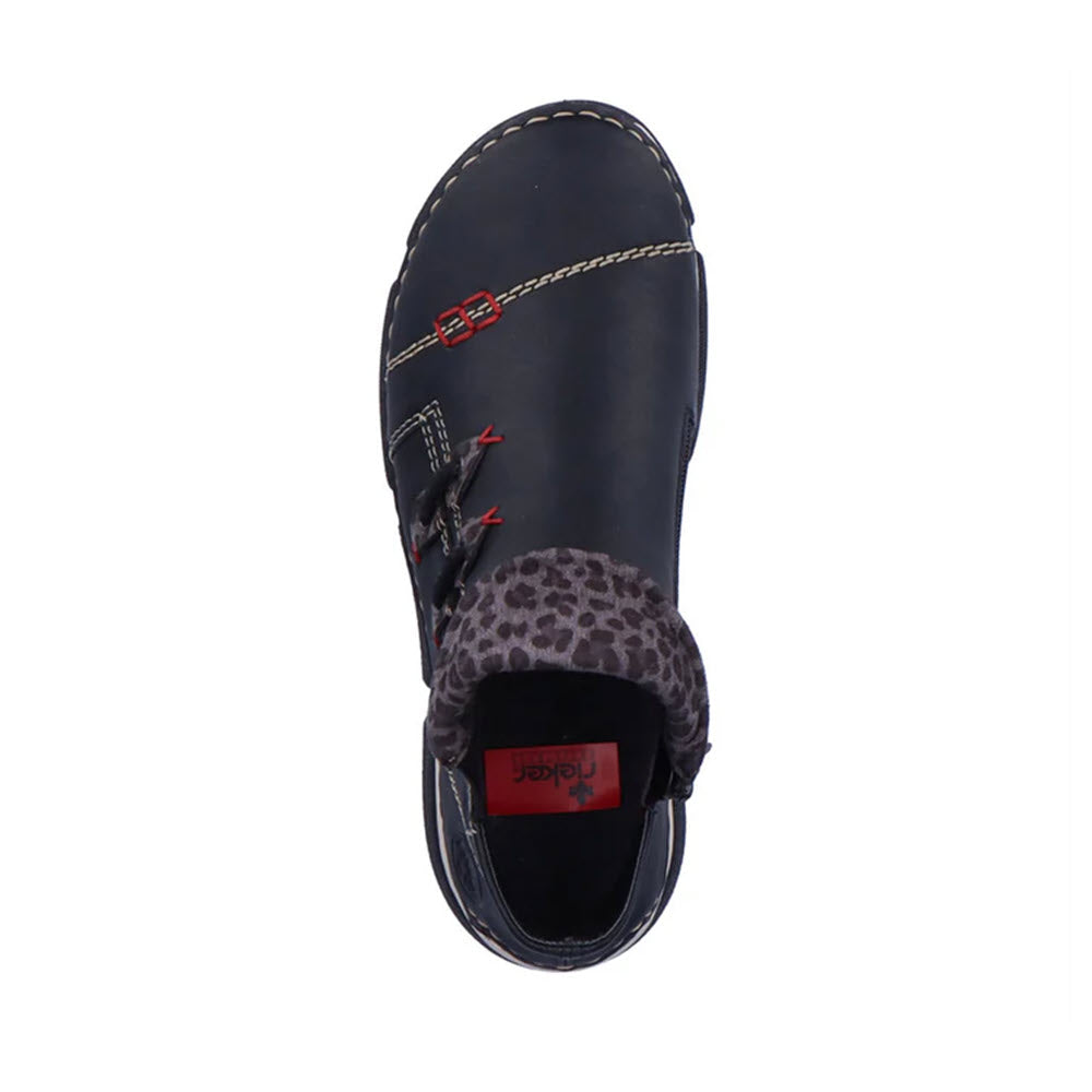 Top view of the Rieker Stretch Jogger Slip On Black Multi women&#39;s sneaker bootie, featuring white stitching, a leopard-print detail at the heel, red accents, and a brand label reading &quot;Rieker&quot; inside.