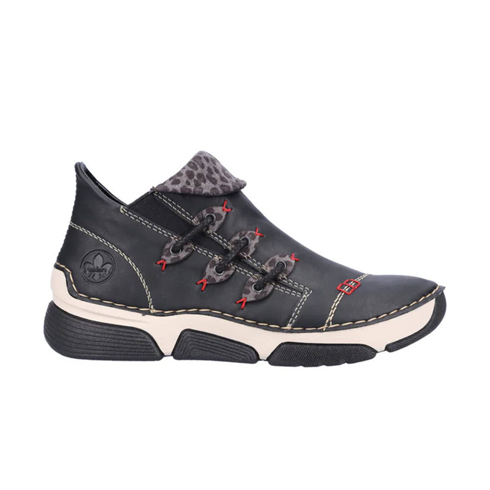 Introducing the Rieker Stretch Jogger Slip On in Black Multi for women. This stylish sneaker bootie features a blend of black with white stitching and red accents, complemented by a thick black and white sole. Decorative laces add flair, while the patterned fabric lining ensures comfort and style.