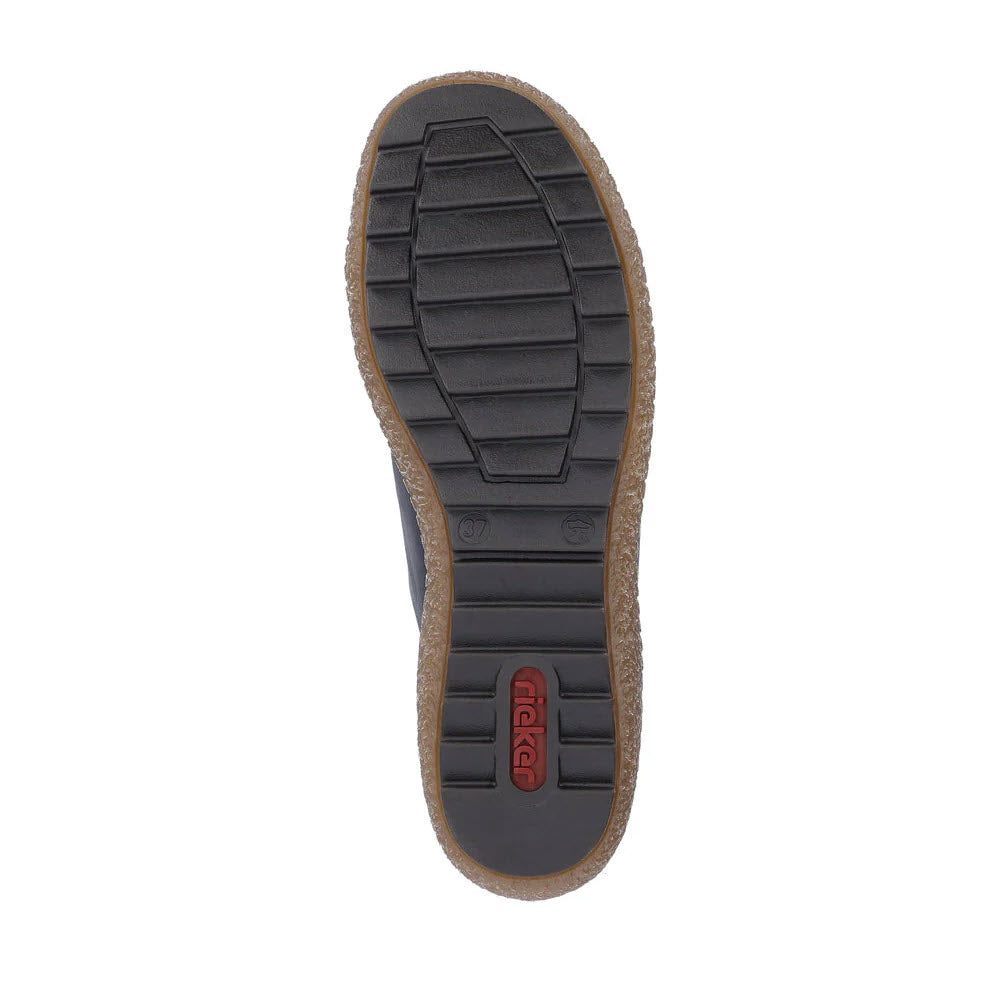 Bottom view of a navy multi Rieker Euro City Slip On Oxford for women, featuring rectangular treads and a raised logo in the center, with a removable insole for added comfort.