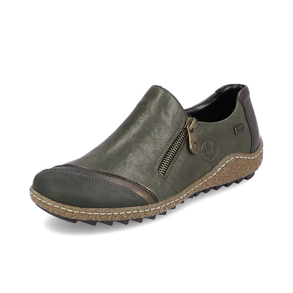 The Rieker Euro City Slip On with Zip Olive for women is a lightweight walking shoe featuring green coloring with brown accents, a convenient side zipper, a textured sole with deep tread, and a logo on the outer side.