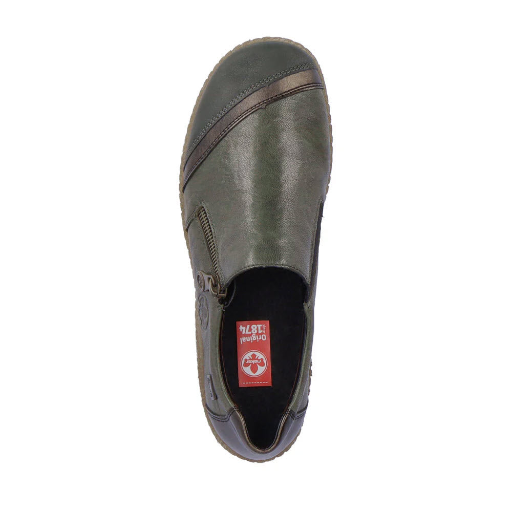 Introducing the RIEKER EURO CITY SLIP ON WITH ZIP OLIVE for women by Rieker. This lightweight, water-resistant shoe in a subtle olive hue features a convenient side zipper and comes with a comfortable red insole decorated with a white logo. It boasts a rounded toe, deep tread for extra grip, and an appealing two-tone design.