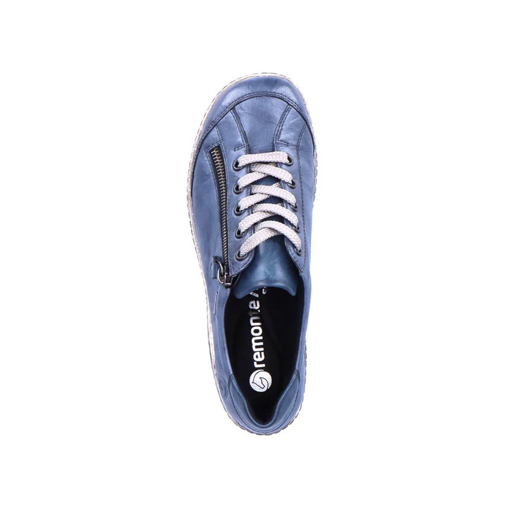 Top view of a single REMONTE EURO CITY WALKER DENIM sneaker for women by Remonte, showcasing its synthetic blue uppers, white laces, and side zipper, with cushioned insoles, set against a white background.