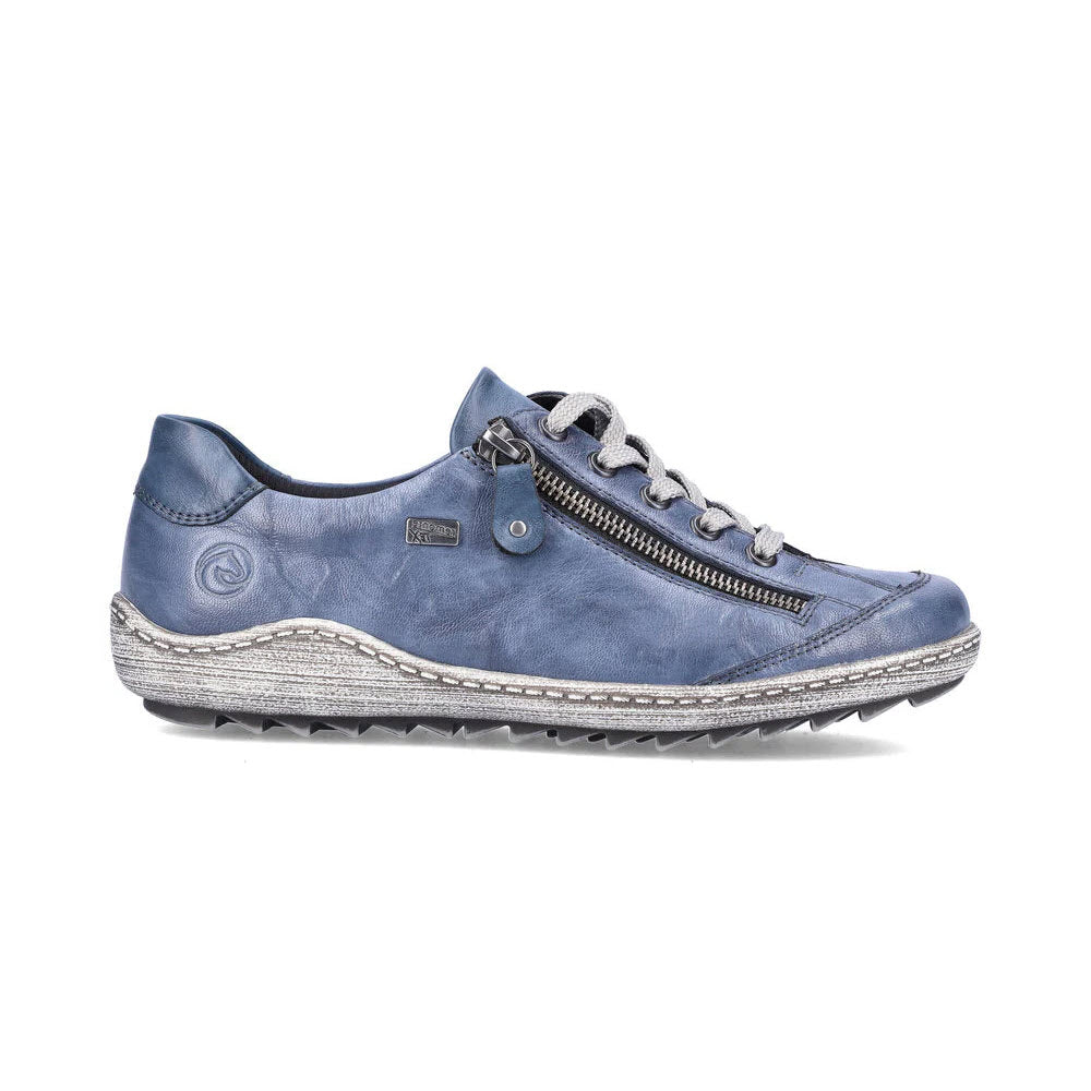 The REMONTE EURO CITY WALKER DENIM for women by Remonte features a blue leather casual sneaker design, equipped with white laces, a side zipper, grey welt stitching, and cushioned insoles for all-day comfort.