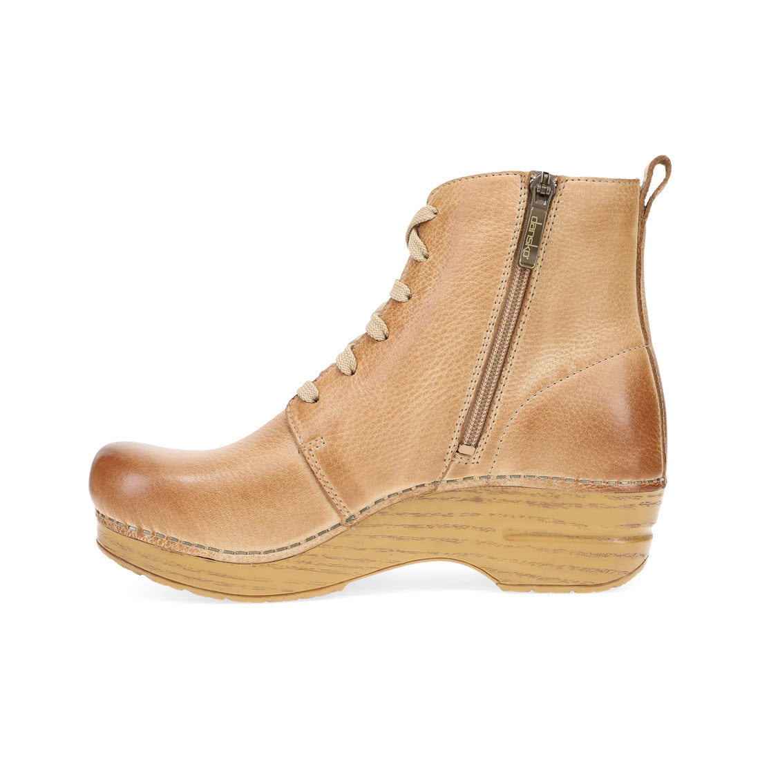 The DANSKO SIGOURNEY HONEY DISTRESSED for women by Dansko is a tan leather ankle boot featuring a side zipper, cozy lace-up front, and a wedge sole—a cold weather favorite.