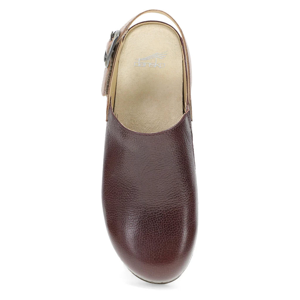 Top view of a single DANSKO MERRIN CORDOVAN - WOMENS clog in brown leather, featuring a heel strap and buckle on the side. The clog has a visible Dansko logo on the insole.