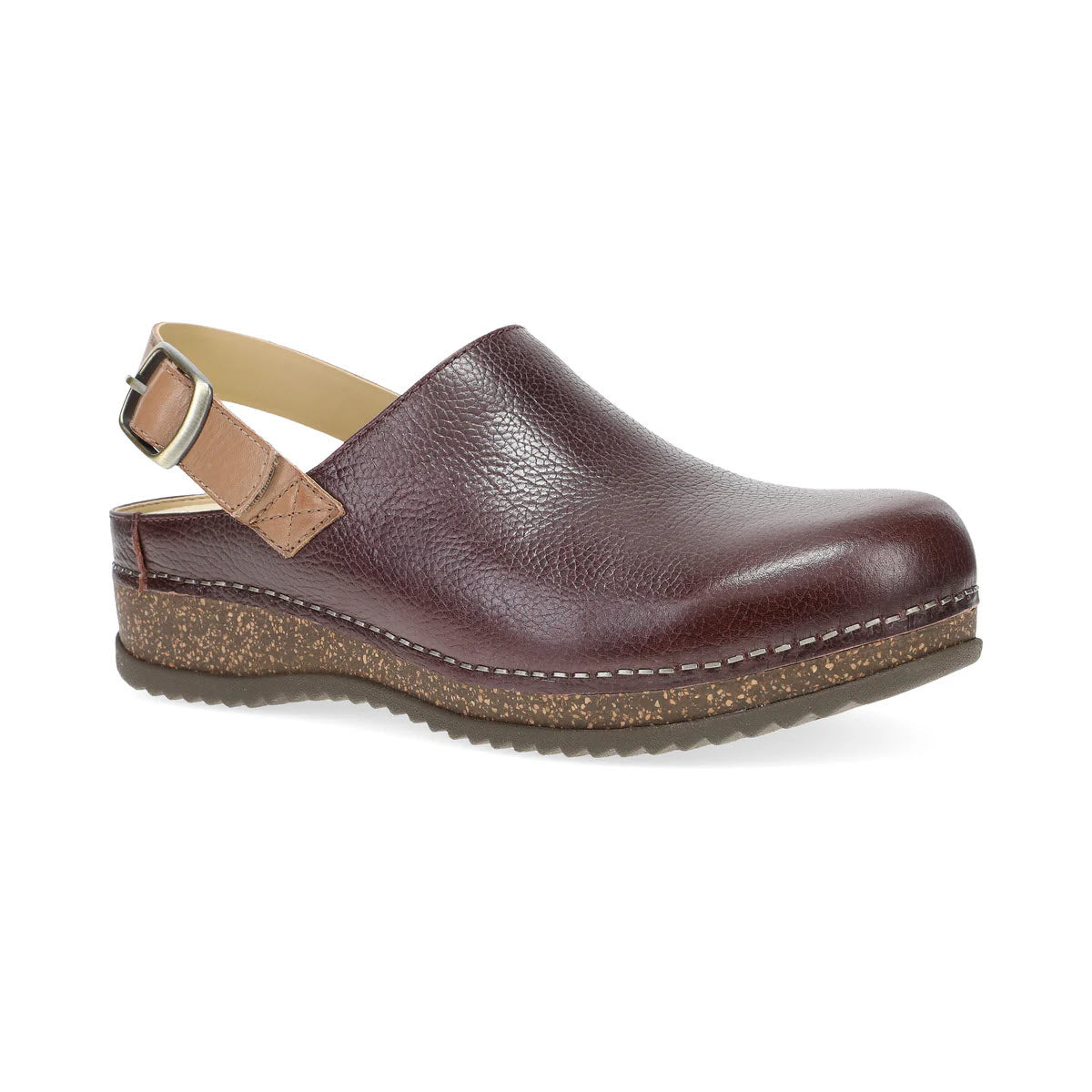 Introducing the DANSKO MERRIN CORDOVAN for women by Dansko: a brown leather clog featuring a heel strap and a cork sole, meticulously designed using waste-reducing methods for an eco-friendly flair. This timeless wardrobe staple provides unparalleled comfort while championing sustainable fashion.

