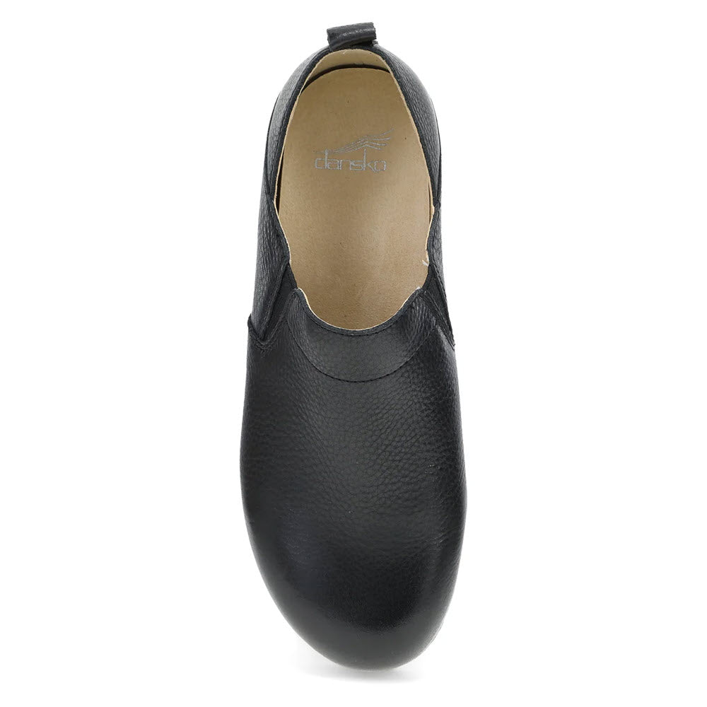 A top-down view of the Dansko Meara Black leather casual slip-on shoe for women, featuring a rounded toe and light beige interior, perfect for comfort anytime, anywhere.