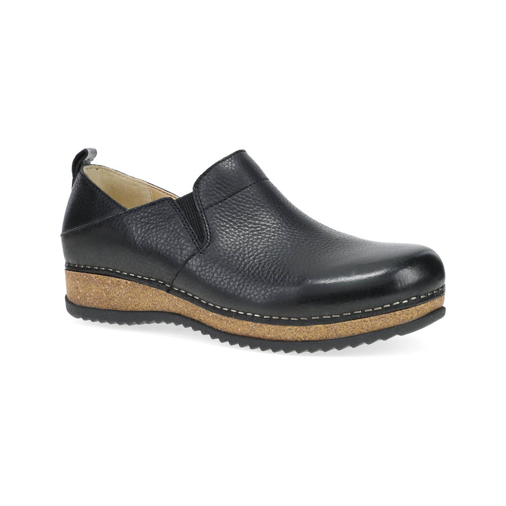 The DANSKO MEARA BLACK - WOMENS by Dansko is a black casual slip-on shoe that boasts a pebble leather finish, complemented by a brown cork-like sole and white stitching around the base. Designed with comfort in mind, it features a slightly raised heel and grooved tread, making it perfect for any occasion.