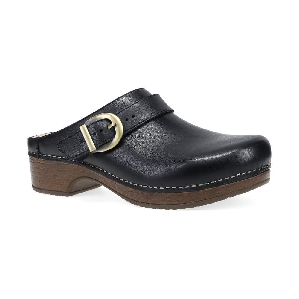 Introducing the Dansko Baylor Black for women: a sleek black leather backless clog featuring a wooden sole, adorned with a striking gold buckle strap and exquisite white stitching detail.