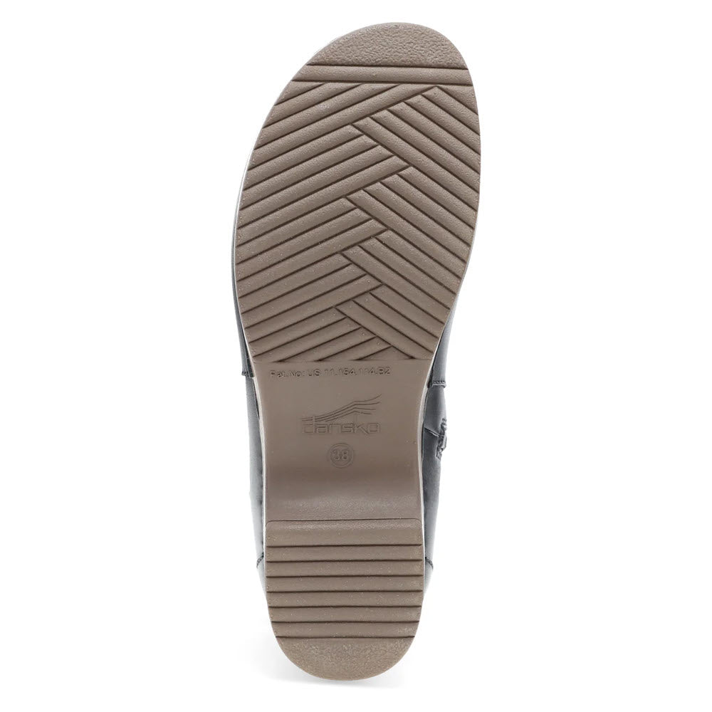 The image shows the sole of the DANSKO BRENNAN BLACK - WOMENS shoe with a herringbone pattern, featuring the word &quot;Dansko&quot; along with size and model number details embossed in the center. The classic rocker sole complements the overall design perfectly.