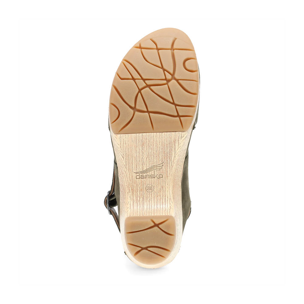 Bottom view of a Dansko Lucia Ivy - Womens closed-toe clog showing a beige sole with brown, wavy grooves for traction.