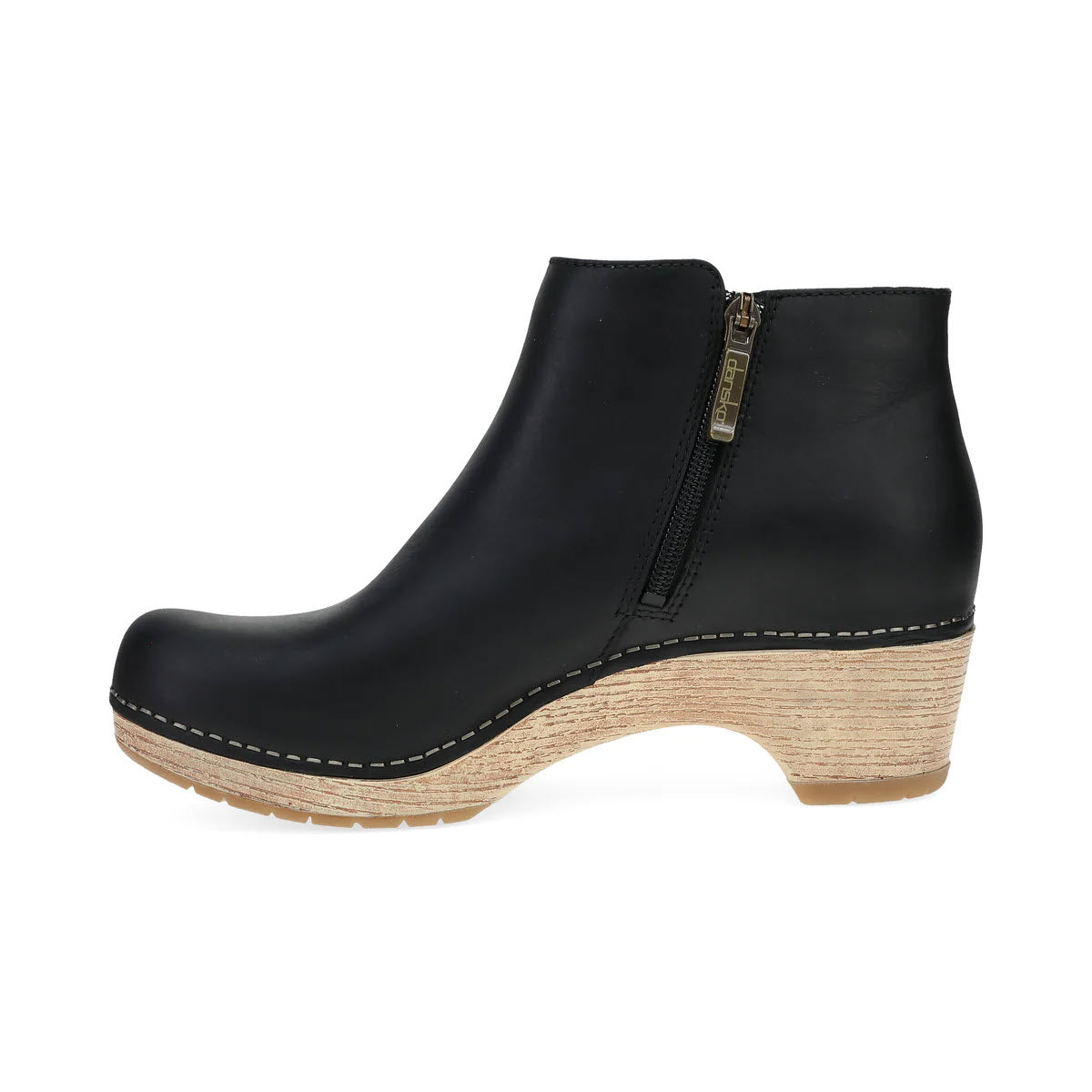 Side view of the DANSKO LIZANNE BLACK - WOMENS ankle boot by Dansko, featuring black leather material, a convenient zipper closure, a distinctive wooden wedge heel, a blonde sole, and elegant beige stitching details. This functional short bootie is designed to offer both style and comfort.