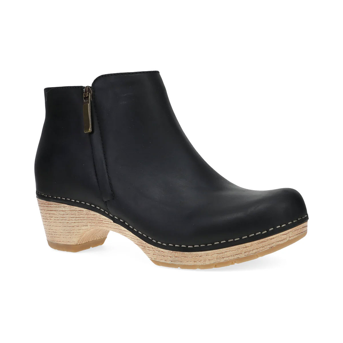 The DANSKO LIZANNE BLACK - WOMENS by Dansko is a functional short bootie in black leather, featuring a wood-like wedge heel, a blonde sole, and a side zipper.