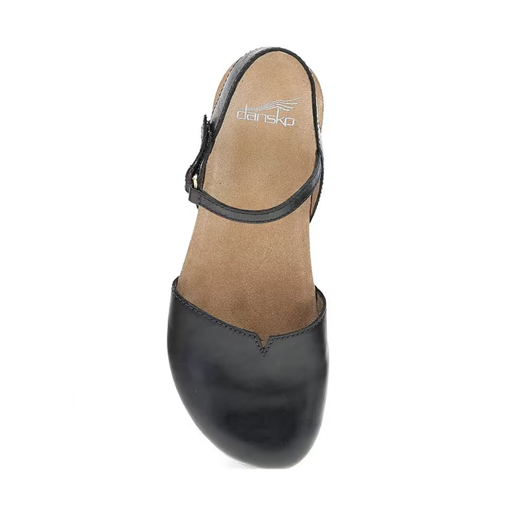 A DANSKO ROWAN BLACK LEATHER - WOMENS with a single strap and buckle, featuring soft leather linings and a memory foam footbed for added comfort, showing the insole labeled &quot;Dansko.